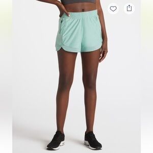 We Wander Women's Athletic Shorts in teal green size medium.